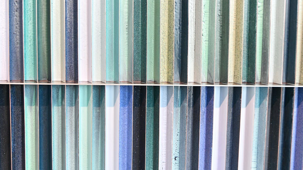 cta-image Close-up of colorful vertical striped glass panels creating a vibrant abstract pattern.
